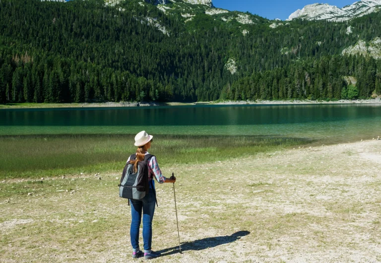 woman-hiker-with-a-backpack-black-lake-hotel-rezident-zabljak woman-hiker-with-a-backpack-black-lake-hotel-rezident-zabljak